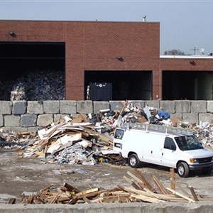 Van backing into disposal facility 